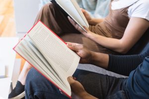 A close up shot of kids reading books