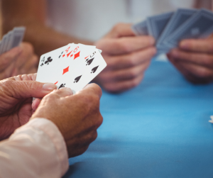 An up close image of people holding cards in their hands