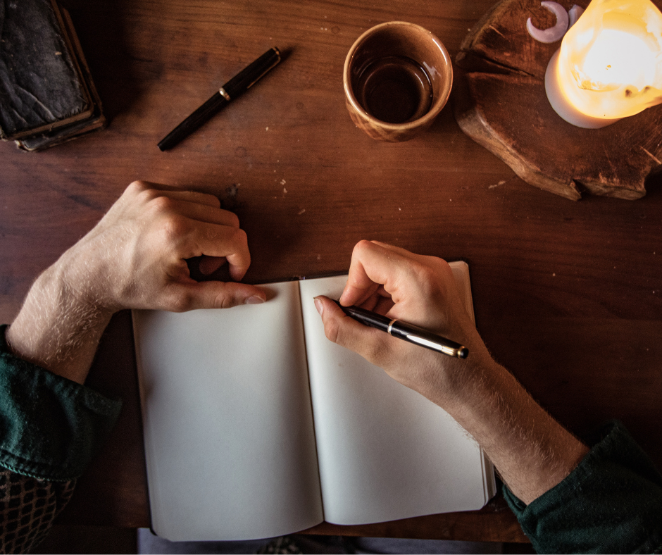 An up close image of someone writing in a journal.