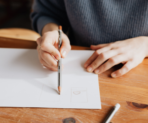 A person drawing with a pencil
