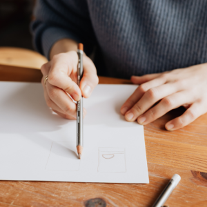 A person drawing with a pencil