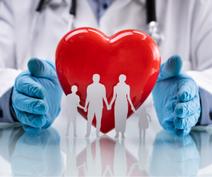A stock photo of a gloved surgeons hands with a paper doll family in front of a red heart Intended to accompany the medicare educational seminar