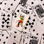 A pile of playing cards splayed out face up on a surface