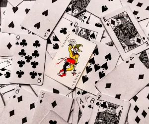 A pile of playing cards splayed out face up on a surface