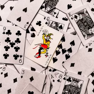A pile of playing cards splayed out face up on a surface