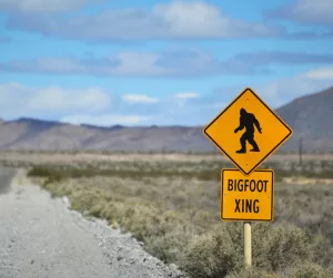 A road sign that says bigfoot x ing