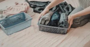 A person organizing clothing into different bins