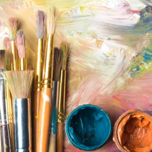 paintbrushes and paints on a table