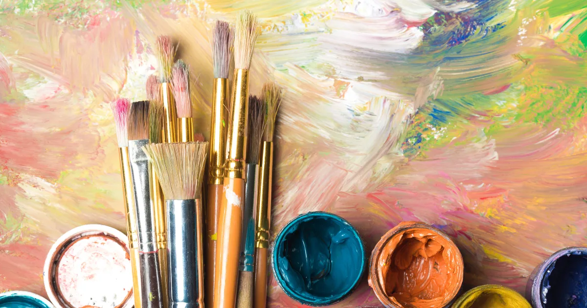 Paintbrushes and paints on a table